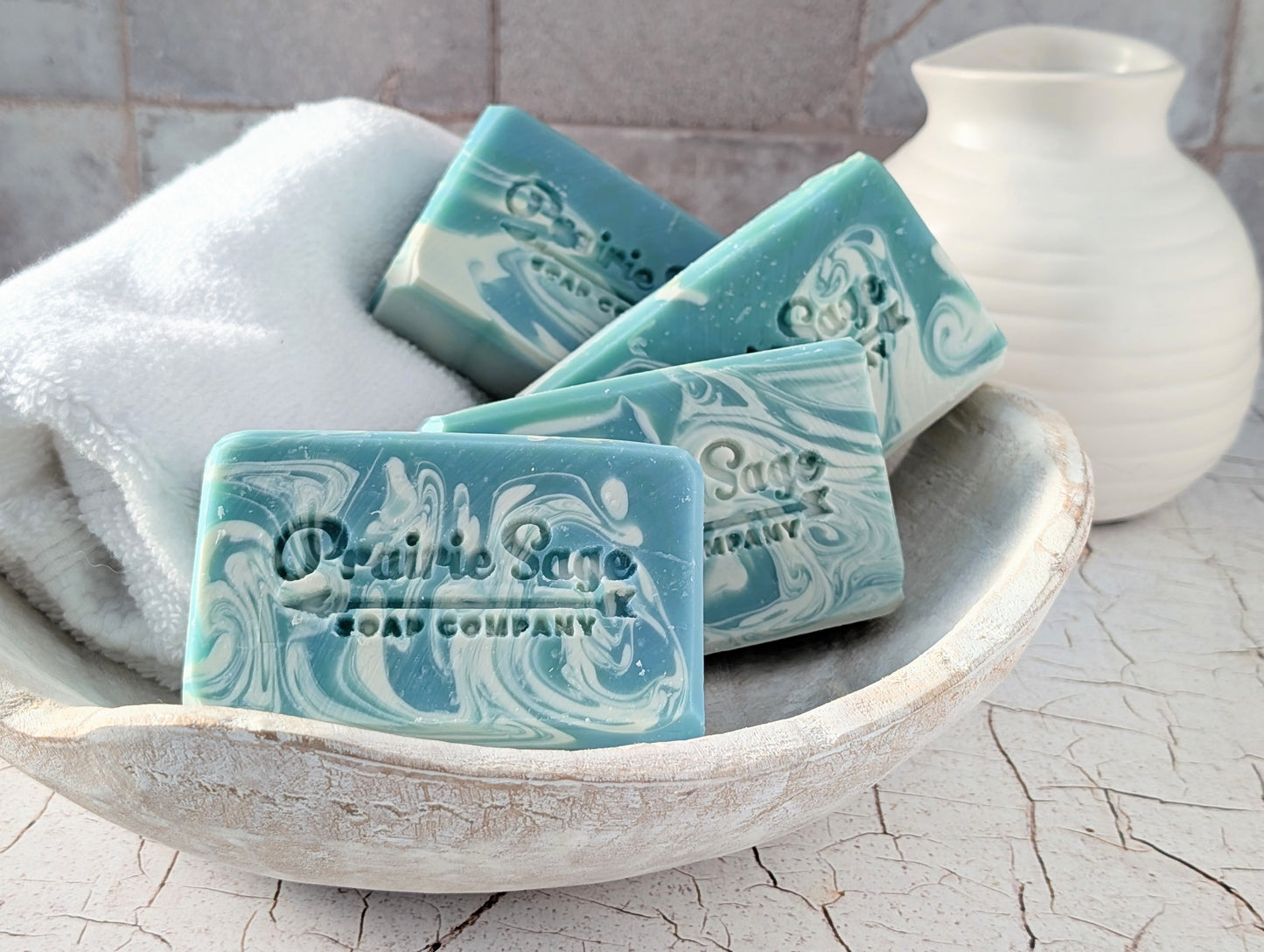 four bars of fresh shave handmade soap in a bowl with a towel