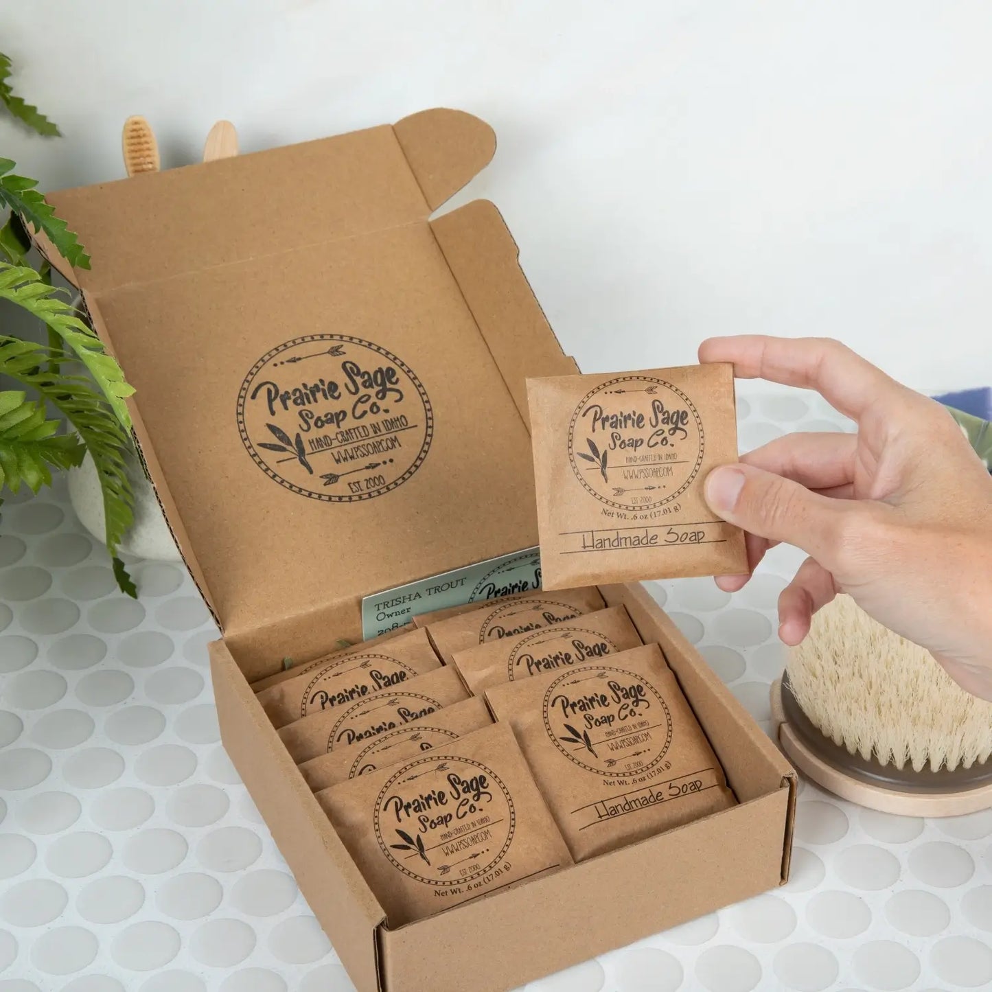 Prairie Sage Soap Co. handcrafted soap box with a hand holding a packaged soap bar.