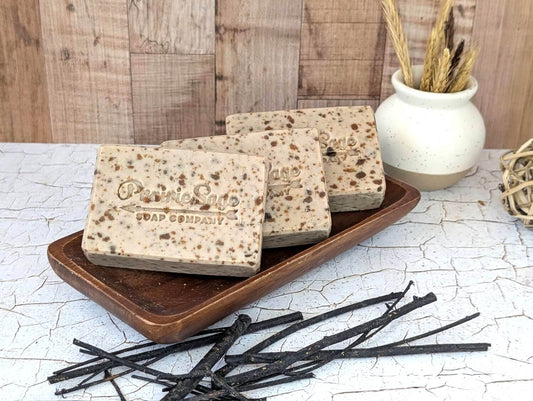 African Fusion handmade soap sitting on a wooden platform