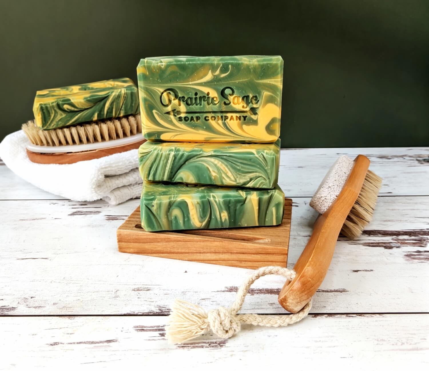 The Cucumber Melon handmade soap sitting on a wooden platform.