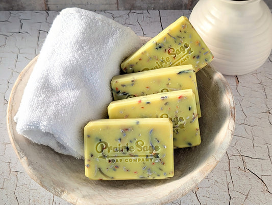 four bars of hello handsome handcrafted soap in a bowl with a towel