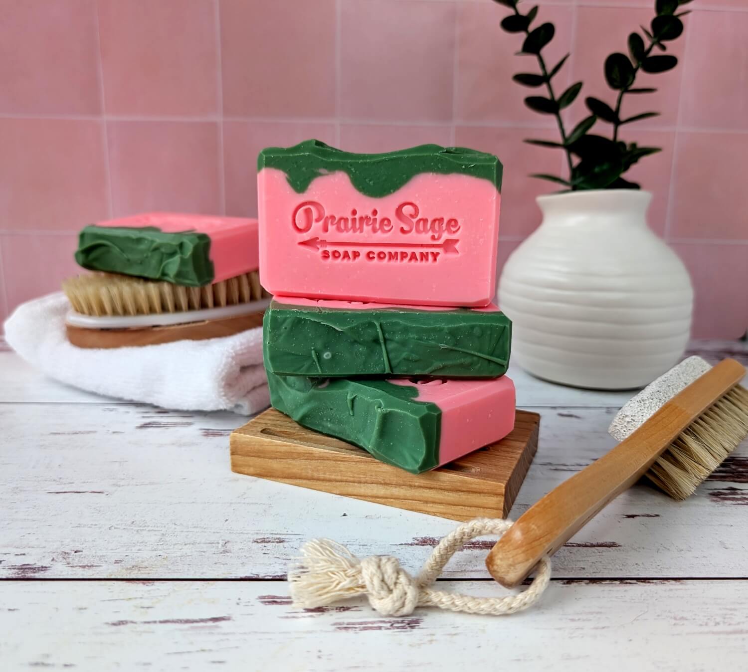 The Pink Watermelon handmade soap sitting on a wooden platform.