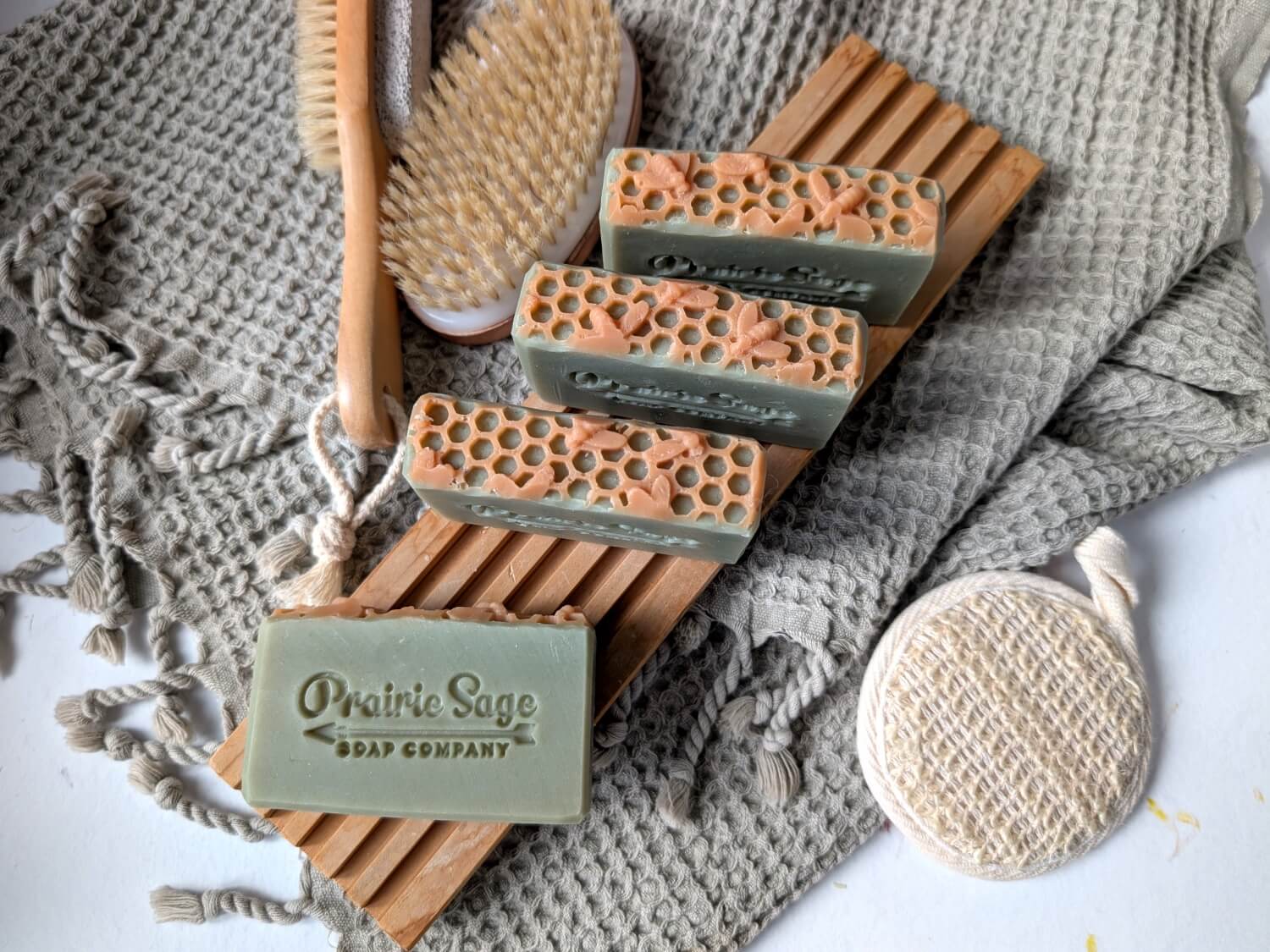 Tuscan Herb and Honey handmade soap on a wooden tablet.
