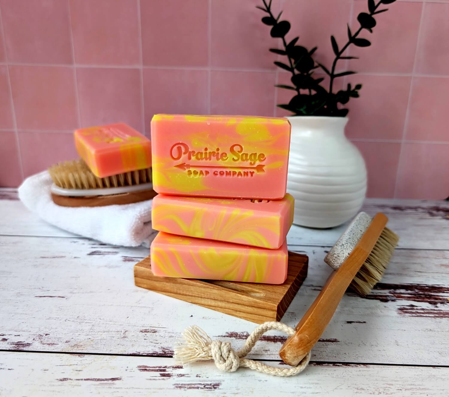 The Watermelon Lemonade handmade soap sitting on a wooden platform.